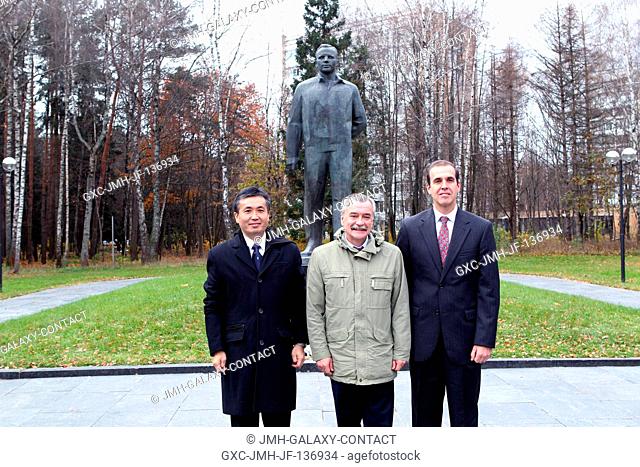 At the Gagarin Cosmonaut Training Center in Star City, Russia, the Expedition 3839 prime crew members pose for pictures in front of the statue of Yuri Gagarin
