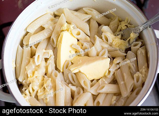 Pasta in a pan with butter close up
