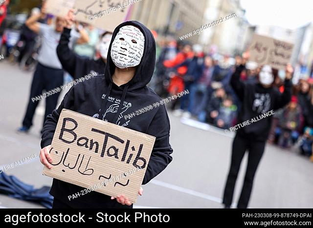 08 March 2023, Berlin: A masked woman takes part in a demonstration by Afghan women's and diaspora groups against the Taliban in Afghanistan