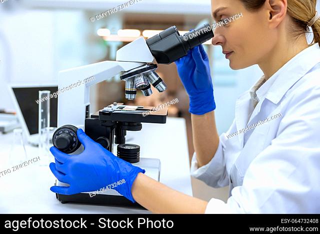 Professional woman scientist working on vaccine in modern scientific research laboratory, genetic engineer workplace. Future technology and science