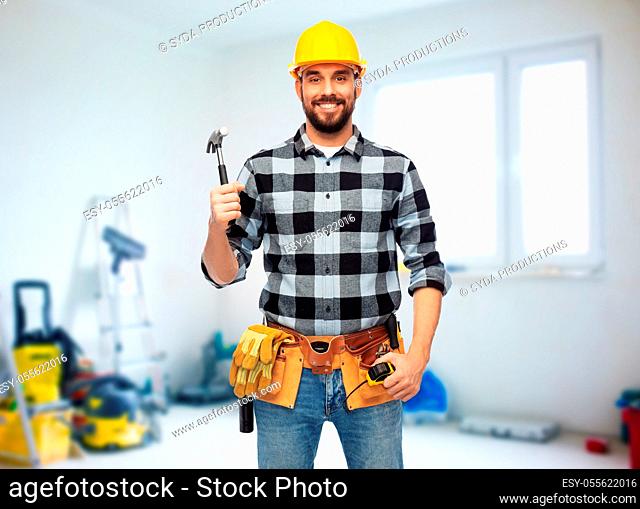 happy male builder in helmet with hammer