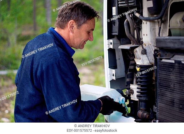The driver who is filling in a liquid in the motor