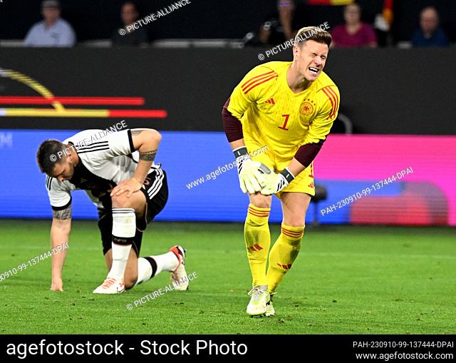10 September 2023, Lower Saxony, Wolfsburg: Soccer: Internationals, Germany - Japan, Volkswagen Arena, Germany's goalkeeper Marc-André ter Stegen (r) holds his...