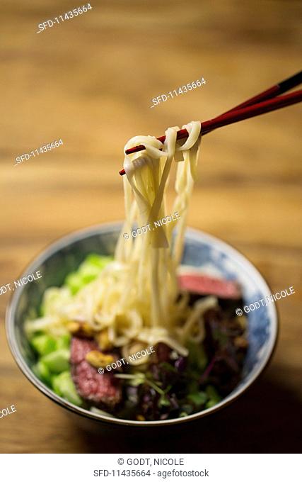 Beef with rice noodles, cucumber, peanuts and chillis with a lime dressing (Asia)