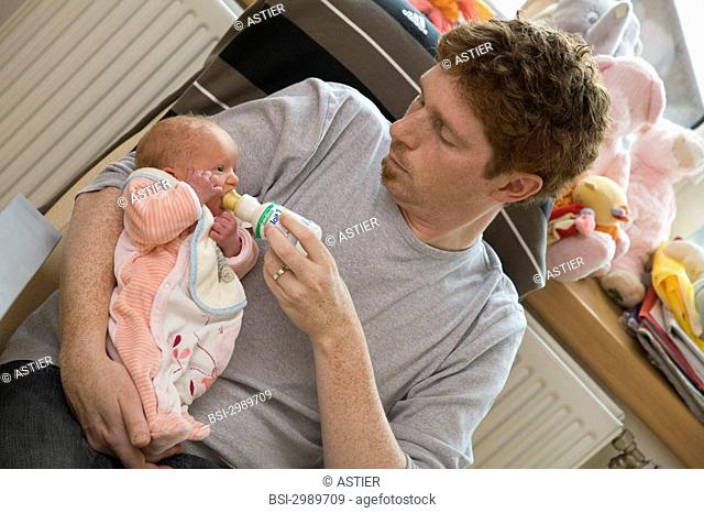 Photo essay at the maternity of Saint-Vincent de Paul hospital, Lille, France. The father with one of his two girl twins