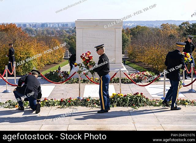 Soldiers with the 3rd U.S. Infantry Regiment, known as ""The Old Guard, "" move flowers during a centennial commemoration event at the Tomb of the Unknown...