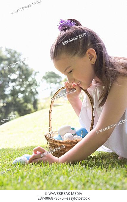 Little girl collecting easter eggs