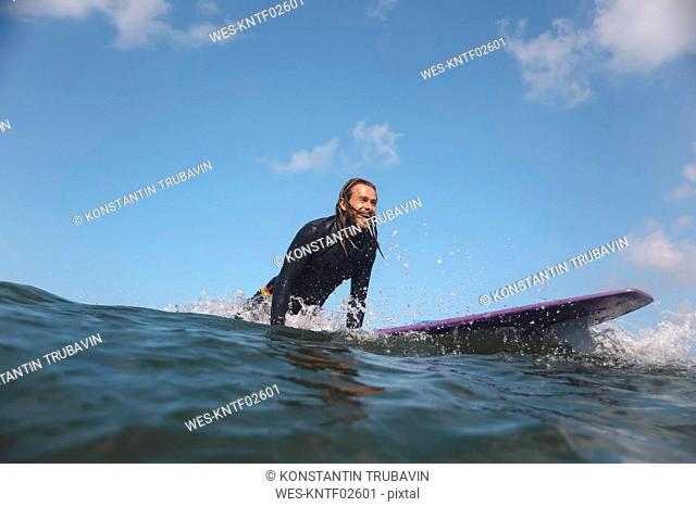 Indonesia, Bali, Canggu, surfer on surfboard