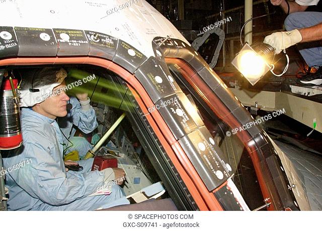 06/08/2002 - STS-107 Pilot William Willie McCool checks the window in Columbia during Crew Equipment Interface Test activities at KSC