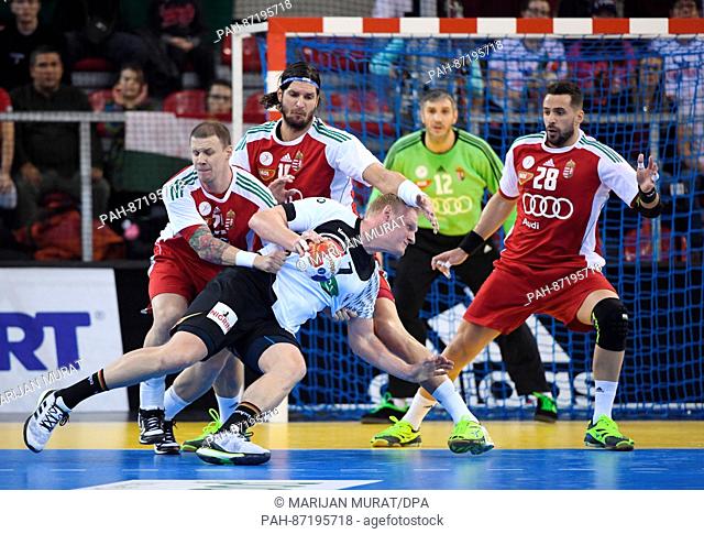 Germany's Patrick Wiencek (in white) in action against (L-R) Hungary's Szabolcs Zubai, Laszlo Nagy, and Szabolcs Szollosi during the men's handball World Cup...
