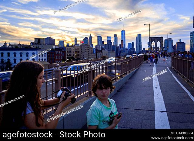 ANCHORAGE PLAZA, New York City, NY, USA, Two kids on Brooklyn Bridge over East River 14 years old caucasian teenager girl and 12 years old caucasian teenager...