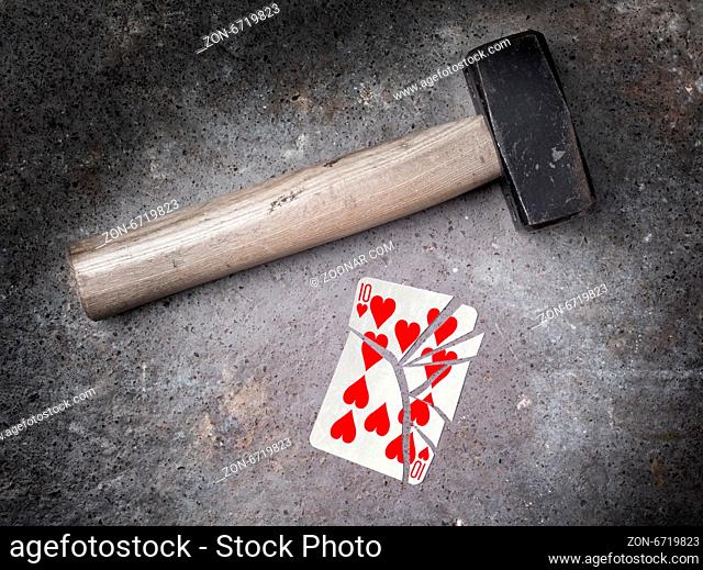 Hammer with a broken card, vintage look, ten of hearts