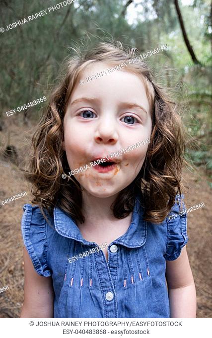 Lifestyle portrait of a three year old girl on a hiking trail in Oahu Hawaii