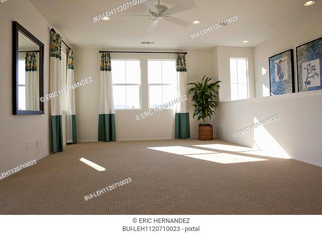 Empty room with carpet on floor and curtains on windows at home; San Marcos; California; USA