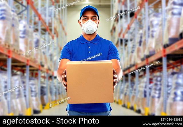 indian delivery man with parcel box in respirator