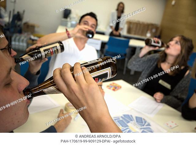 Subjects drink beer in Mainz, Germany, 16 June 2017. The University of Mainz examines the effectivicty of an anti-hangover remedy in a scientific study