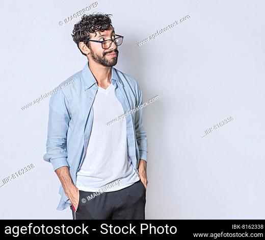 Young man wondering with hand in pocket over isolated background, handsome guy thinking looking to side