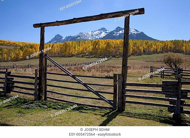 Wooden fence frames San Juan Mountains, Last Dollar Ranch, Hastings Mesa, near Ridgeway, CO