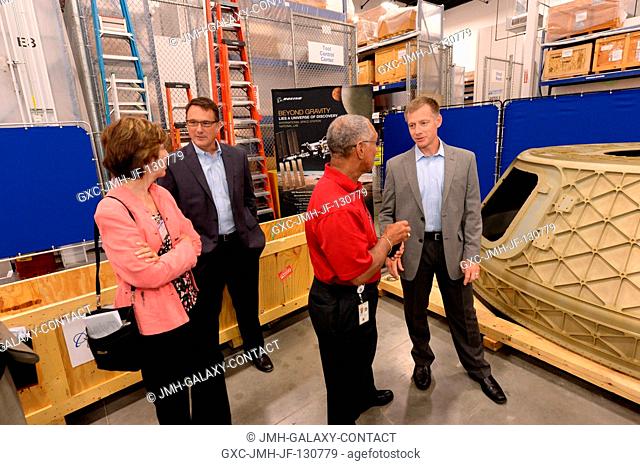 NASA officials visited Boeing's Houston Product Support Center Aug. 19, 2013, and checked out a mock-up of the CST-100 (Crew Space Transportation) crew capsule