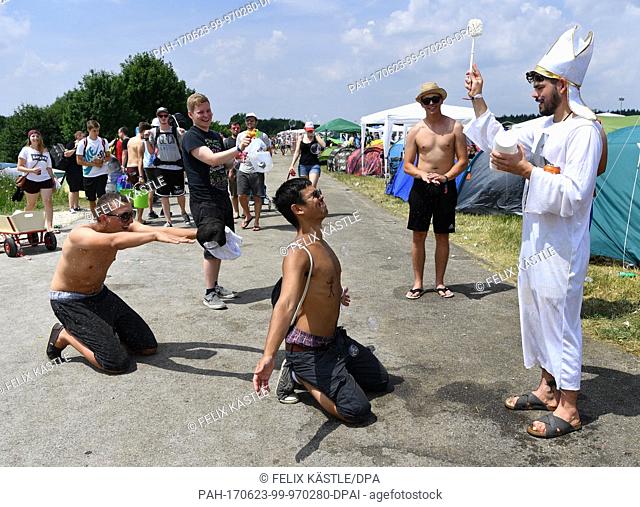 A festival goer from Munich is baptized with a toilet brush on the first day of the Southside Festival in Neuhausen ob Eck, Germany, 23 June 2017