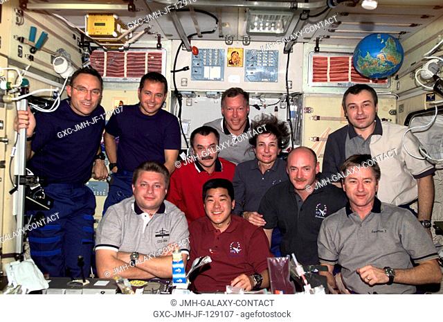 The Expedition Three, STS-108, and Expedition Four crews assemble for a group photo in the Zvezda Service Module on the International Space Station (ISS)