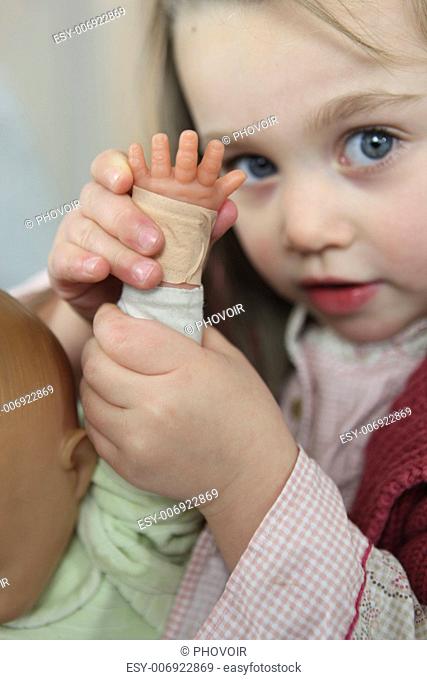 Little girl playing with doll