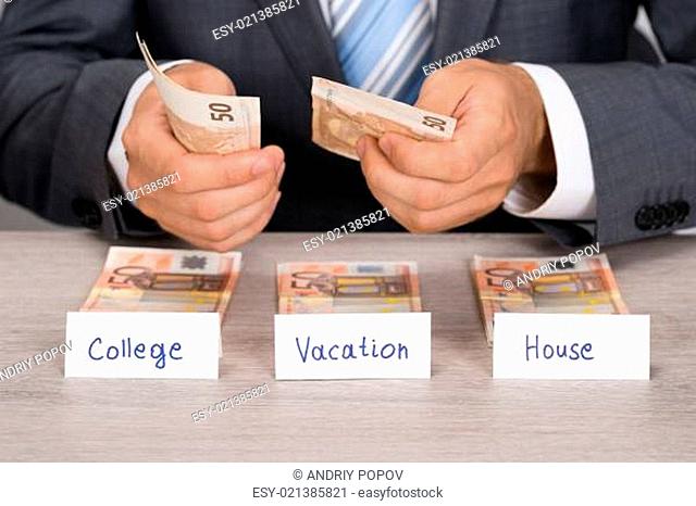 Businessman Saving Money For College Vacation And House