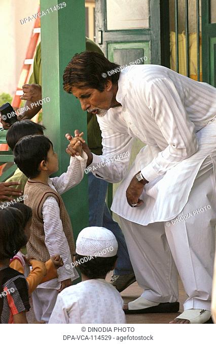 South Asian Indian Bollywood actor Amitabh Bachchan with children at an event at film city ; Bombay Mumbai  ; Maharashtra ; India NO MR