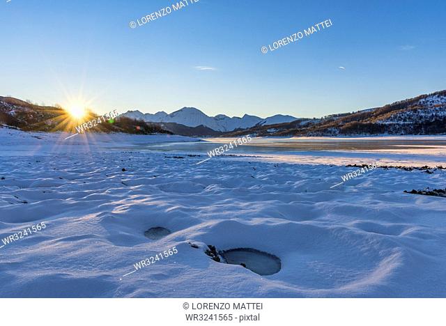 Campotosto Lake in winter at sunrise, Gran Sasso National Park, Abruzzo, Italy, Europe