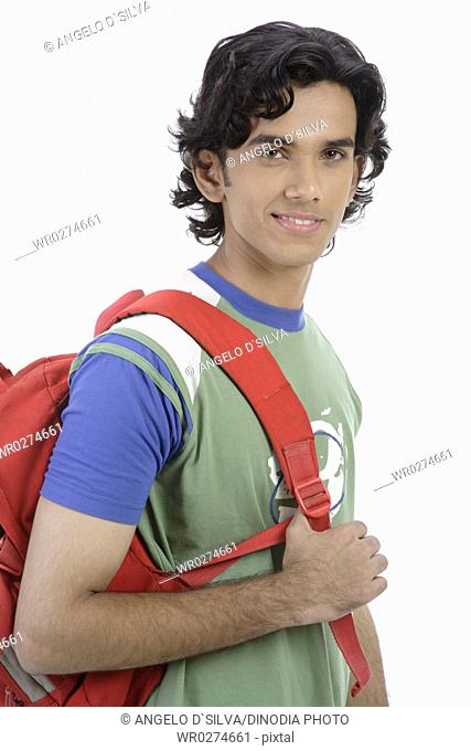 Teenage boy holding red coloured back bag look like college student MR 687T
