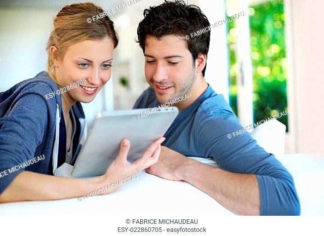 Young couple using electronic tablet