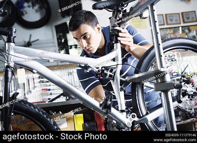 Man repairing bike in bike shop