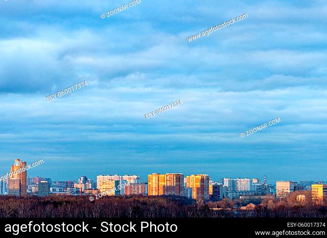 dark blue clouds over modern residential district in Moscow city in spring evening