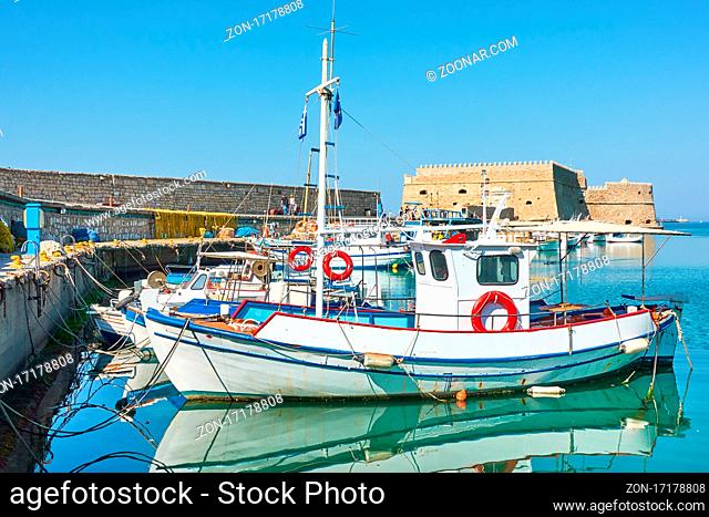 Heraklion in Greece. Fishing boats in the harbour near the old venetian fortress, Crete Island