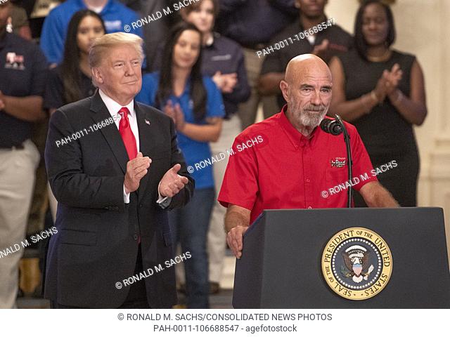 Carl Greene, DED Road Team Member, American Trucking Associations, right, makes remarks as United States President Donald J