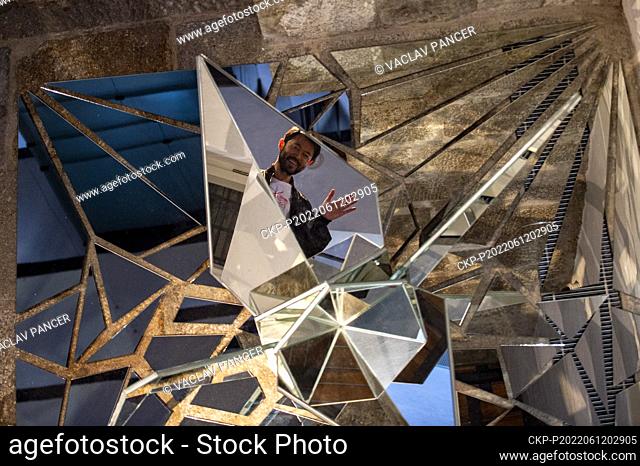 Japanese sculptor Test Ohnari poses with his mirror origami at Egon Schiele Art Centrum in Cesky Krumov, Czech Republic, on June 12, 2022