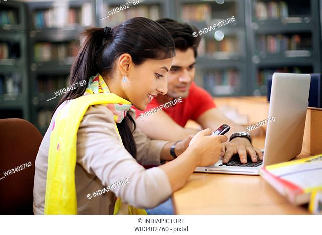 College student looking at sms on mobile phone