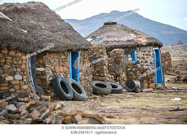 Village huts with tires leaning against them in Sani Pass, Lesotho, Africa