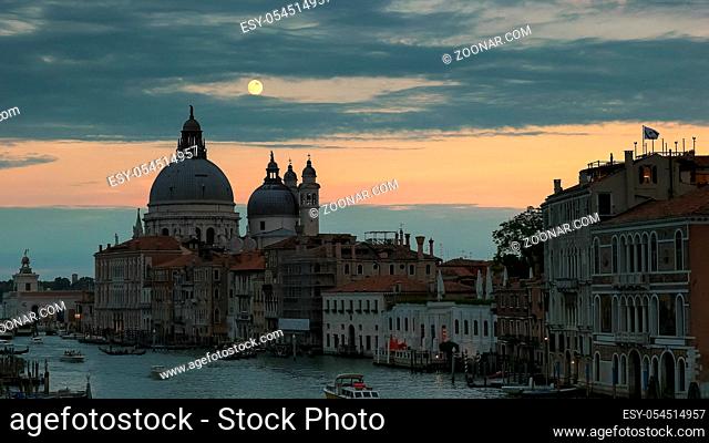 a full moon rises over the basilica st mary in venice, italy