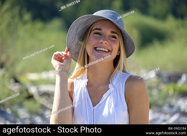 Portrait young blonde woman with sun hat in summer, Bavaria, Germany, Europe