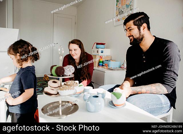 Girl having tea party with parents