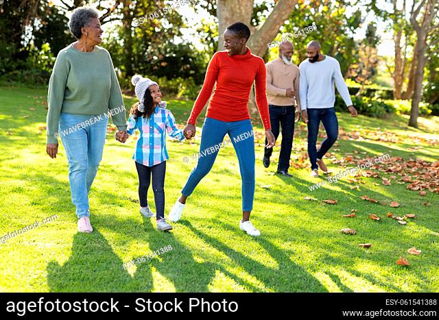 Image of happy multi generation african american family spending time in autumn garden