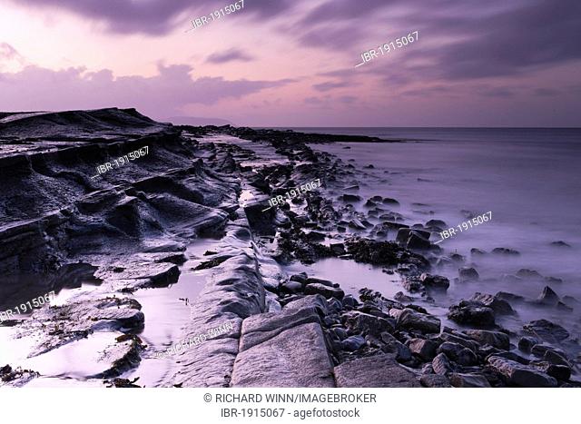 East end of Kilve Beach towards the west, along one of the shelves on an outgoing tide at dusk, Somerset, England, United Kingdom, Europe