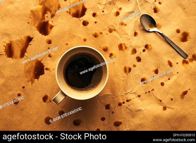 Coffee cup and spoon with splashes