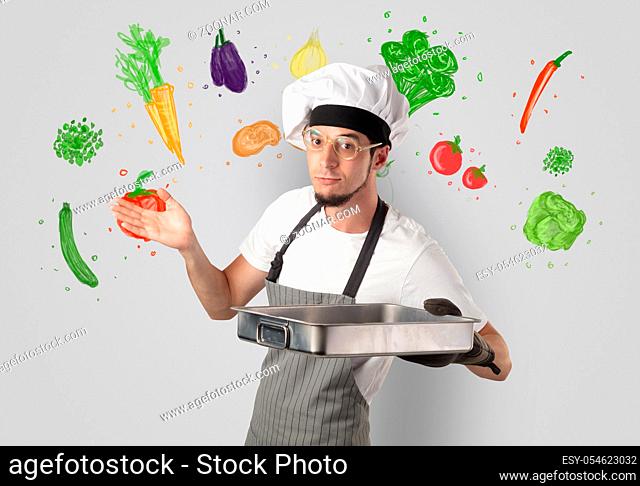 Bearded cook with colourful drawn vegetables on a white wallpaper