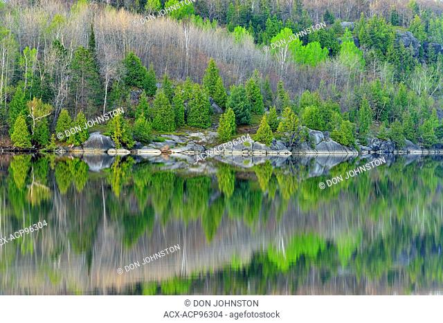 Spring reflections in Simon Lake, Greater Sudbury, Ontario, Canada