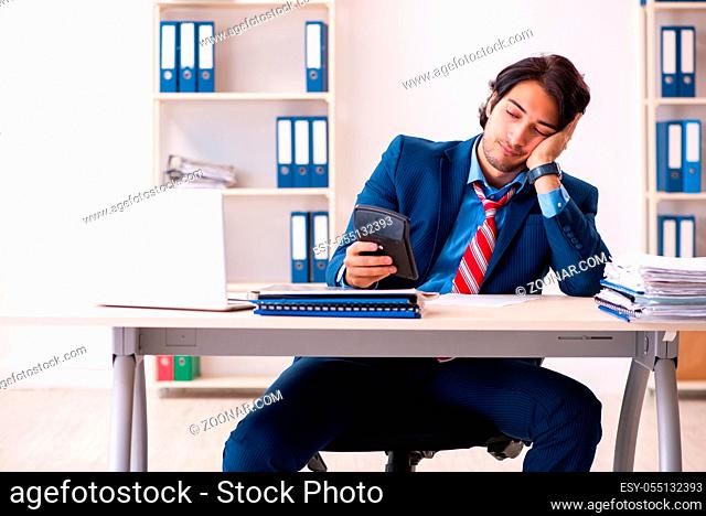 Young handsome businessman sitting in the office
