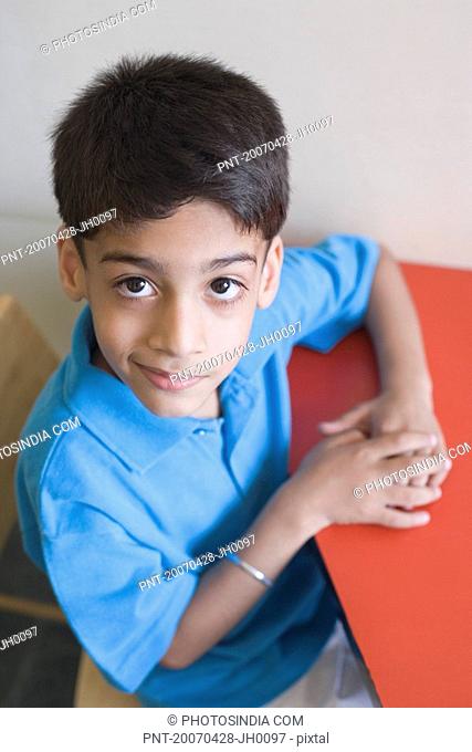 Young Indian boy with a big smile and wet hair wearing a blue shirt looking  up, Stock Photo, Picture And Rights Managed Image. Pic. M57-363644 |  agefotostock