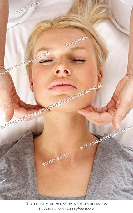 Woman having Shiatsu massage to head