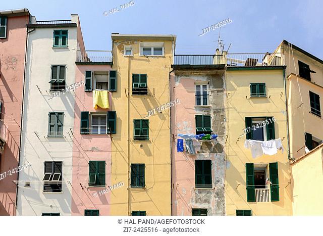view of a row of historical traditional houses on embankment in a sunny spring day, Portovenere, Italy